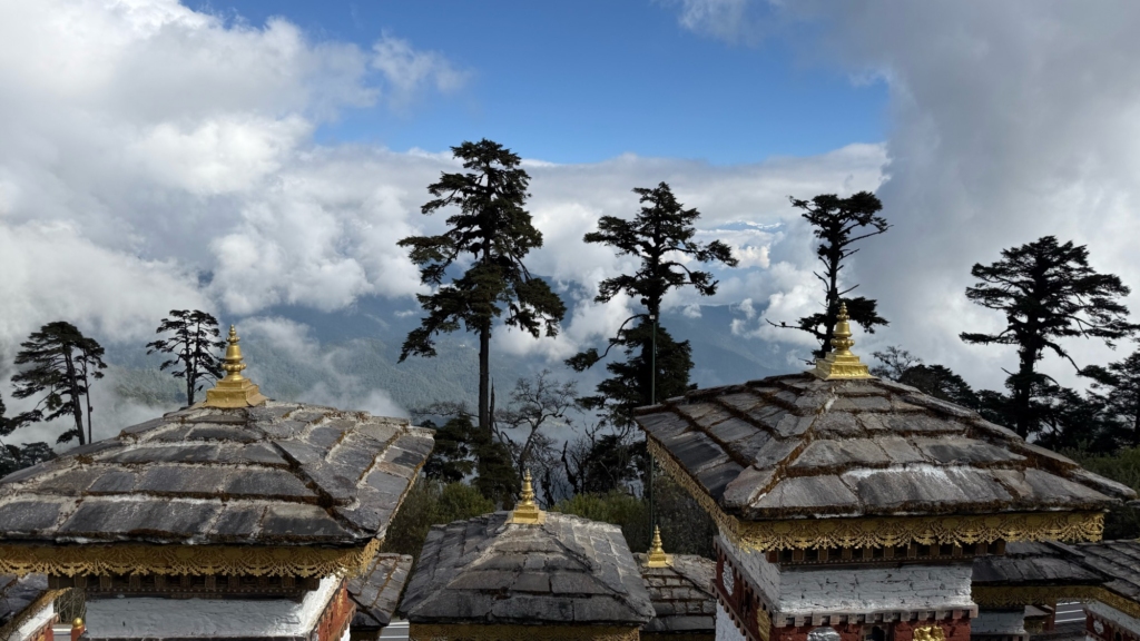 The 108 Druk Wangyal Chortens on the Dochu La pass, arranged on a small hill against the backdrop of the sky.